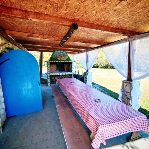a large bed in a room with a wooden ceiling at Kuća za odmor Veles in Orahovica