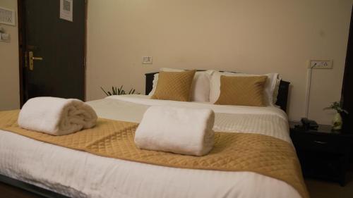 a bedroom with a large bed with towels on it at Ha Sharing in Shillong