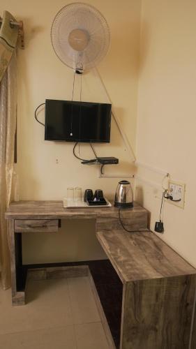 a room with a wooden table with a fan at Ha Sharing in Shillong