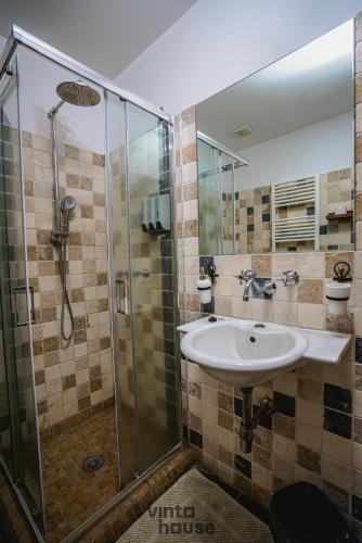 a bathroom with a sink and a shower at Libera Mente Civita in Bagnoregio