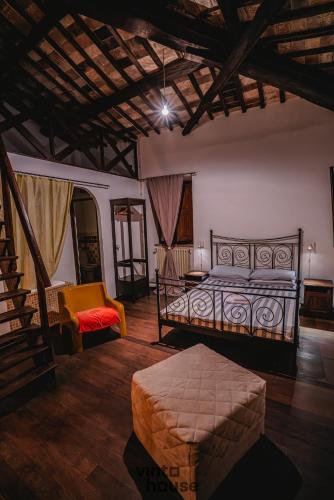 a bedroom with a bed and a couch and a chair at Libera Mente Civita in Bagnoregio