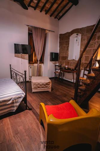 a living room with a couch and a staircase at Libera Mente Civita in Bagnoregio