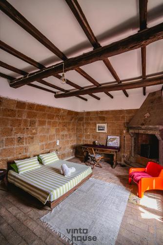 a living room with a couch and a brick wall at Libera Mente Civita in Bagnoregio