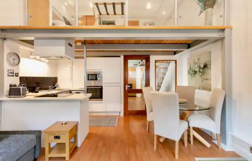 a kitchen and living room with a table and chairs at Lux Apartment in Nottingham