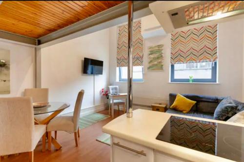 a living room with a couch and a table at Lux Apartment in Nottingham