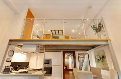 a room with a kitchen and a living room at Lux Apartment in Nottingham