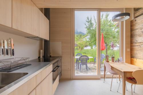 a kitchen with a table and a large window at Gädeli in Sachseln