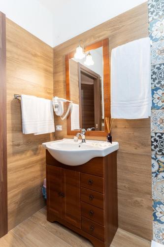 a bathroom with a sink and a mirror at B&B Gusto West in Bisignano