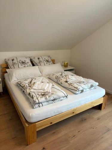 a bed with white sheets and pillows on it at Ferienwohnung Auf der Höhe in Erbach im Odenwald