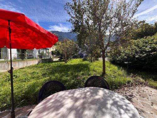 a table and chairs with a red umbrella at Gädeli in Sachseln