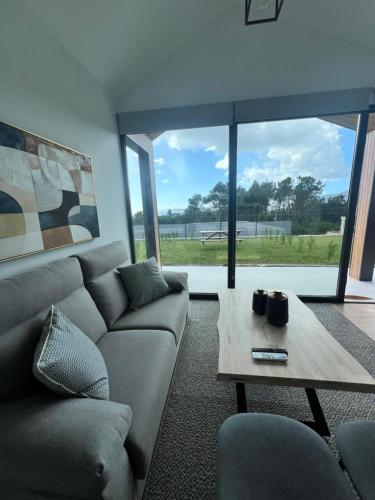 a living room with a couch and a table at OS BALCONS RÍA DE AROUSA II in Boiro