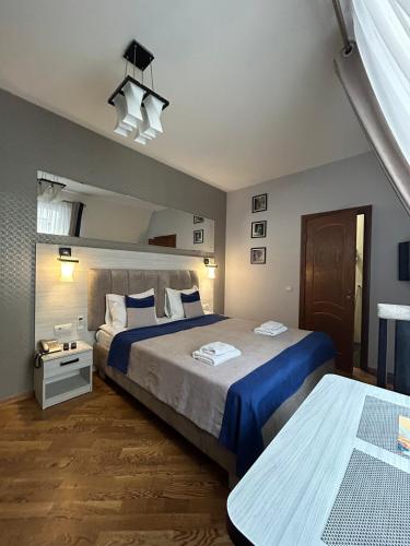 a bedroom with two beds with blue sheets at ANTARES Apart hotel in Lviv