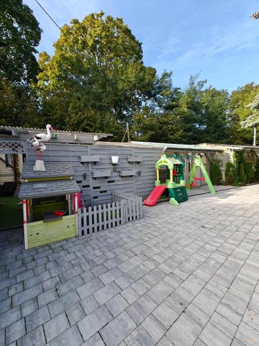 a backyard with a playground and a play set at Willa Rybacka in Krynica Morska
