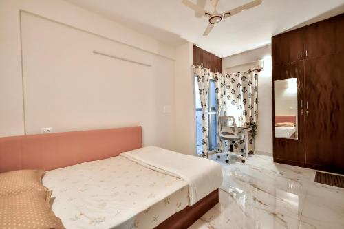 a bedroom with a bed and a chair in it at Namma HomeSlice, Balcony Rooms in Brookefield in Bengaluru