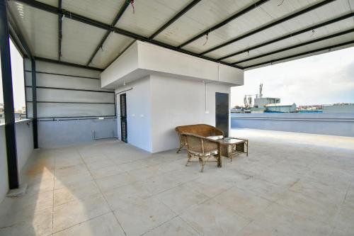 a room with a table and a chair on a roof at Namma HomeSlice, Balcony Rooms in Brookefield in Bengaluru