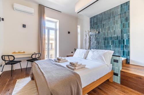 a bedroom with a bed with a glass wall at Palazzo Italia Suites in Bari