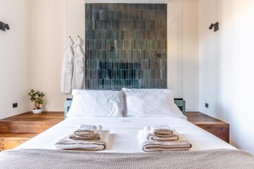 a bedroom with a bed with towels on it at Palazzo Italia Suites in Bari