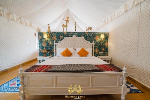 a bedroom with a white bed in a room at highness camp jaisalmer in Sām