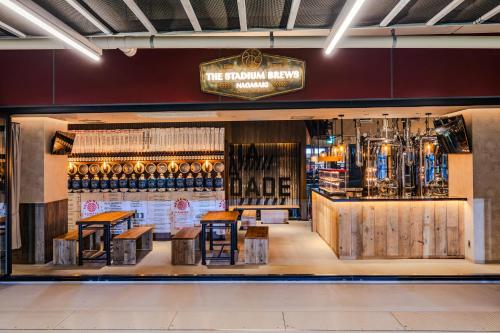 a store with wooden tables and chairs and a bar at Stadium City Hotel Nagasaki in Nagasaki