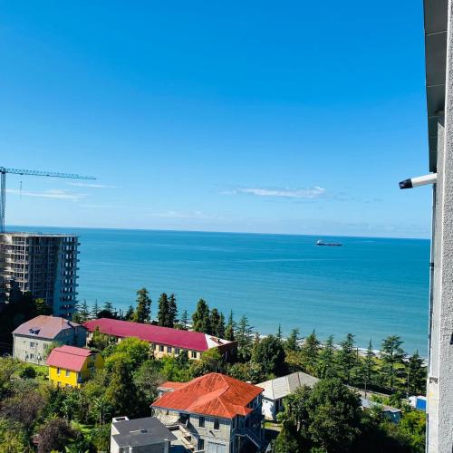 a view of the ocean from a building at green house in Batumi