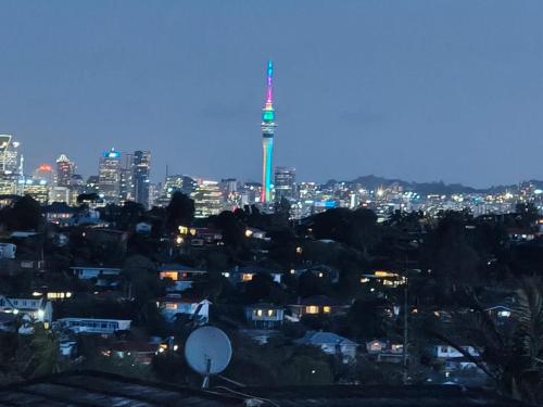 a view of a city at night with a tower at Stylish Family Retreat in Hillcrest 4 Bedroom and Playroom in Auckland