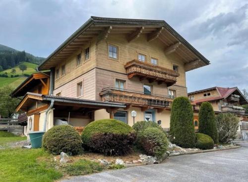 a large house with bushes in front of it at Haus Eckhausl Family in Bramberg am Wildkogel