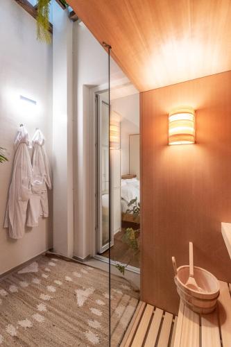 a bathroom with a walk in shower and a glass door at Palazzo Italia Suites in Bari