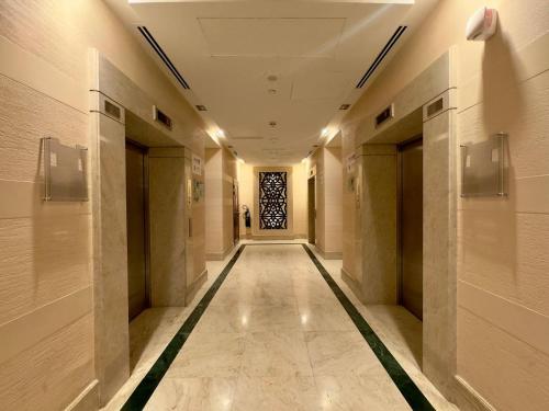 a hallway of a building with a window at Aesthetic Beach Apartment , Sleeps 6, Pool, Gym & Waterfront Views in Dubai