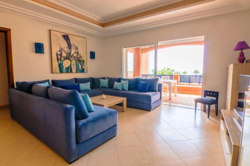a living room with blue couches and a large window at Paradis Bleu - Piscine - Luxe - 4 Px in Imi Ouaddar
