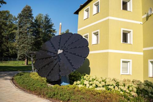 a large black umbrella in front of a building at Apartmány na Dolní in Rumburk