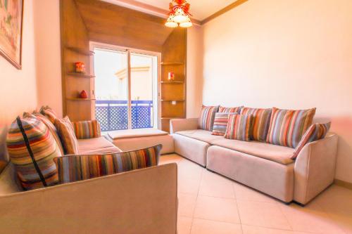 a living room with two couches and a window at Paradis Bleu - Piscine - Luxe - 4 Px in Imi Ouaddar