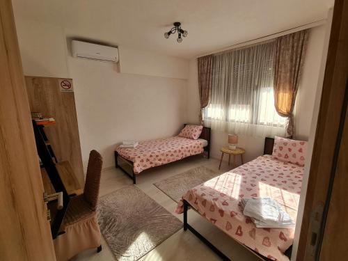 a small room with two beds and a window at Sirob bubanj in Kragujevac