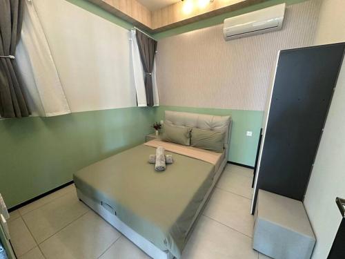 a small room with a bed in a room at High Floor, 3BR 3queen bed, 2 parking, Urban Suites by XWHome in Jelutong