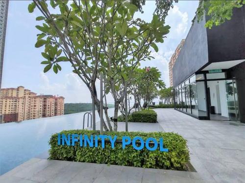 a sign for an infinity pool in front of a building at High Floor, 3BR 3queen bed, 2 parking, Urban Suites by XWHome in Jelutong