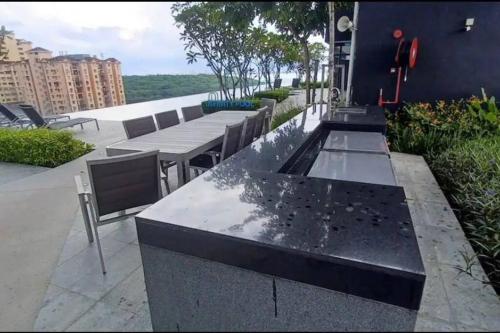 a group of tables and chairs on a patio at High Floor, 3BR 3queen bed, 2 parking, Urban Suites by XWHome in Jelutong