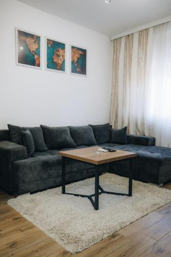 a living room with a couch and a coffee table at DUGA PARK lux in Kragujevac