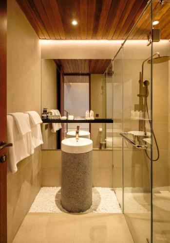 a bathroom with a sink and a glass shower at Two Thirds Villa Canggu in Canggu