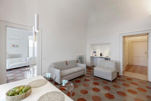 a living room with a couch and a chair at Antica Dimora sul Mare - Luxury Central Apartments - Molfetta in Molfetta