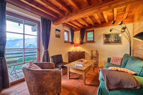 a living room with a couch and a table at Chalet il fera beau demain in Villard-Reculas