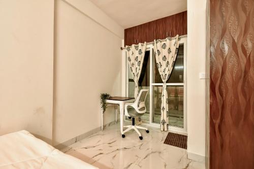 a bedroom with a desk and a window at Namma HomeSlice, Balcony Rooms in Brookefield in Bengaluru