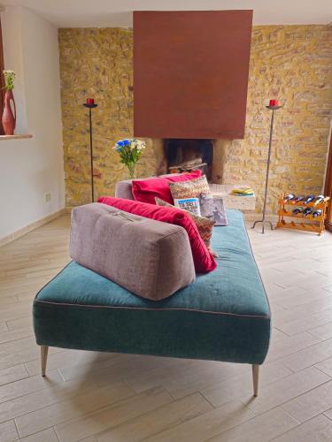 a bed with pillows on top of it in a room with a fireplace at Villa delle lucciole in Massa Martana