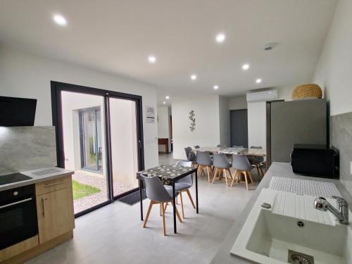 une cuisine et une salle à manger avec une table et des chaises dans l'établissement Stop Chez M Vibe #Climatisation #Parking #Cozy, à Vénissieux
