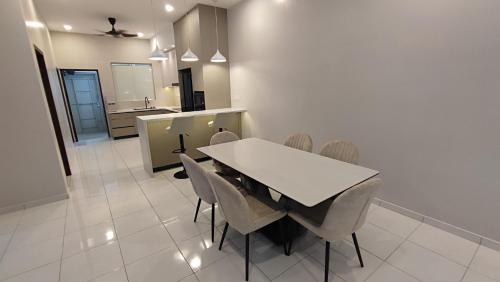 a dining room with a white table and chairs at Minimalist Heaven Near Tmn Intan in Sungai Petani