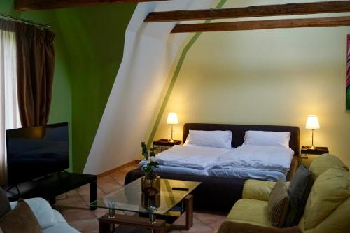a bedroom with a bed and a couch and a table at Ferienwohnung 1 beim Restaurant Rhodos in Heide