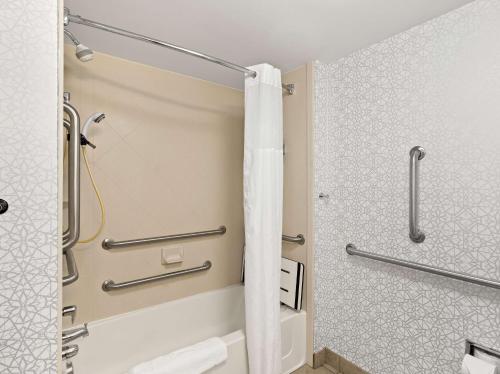 a bathroom with a shower and a toilet at Hampton Inn Blytheville in Blytheville