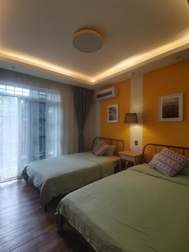 a hotel room with two beds and a window at XiXi Lakeside Inn in Guilin