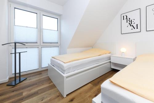 Ένα ή περισσότερα κρεβάτια σε δωμάτιο στο Ferienhaus Küstenfein