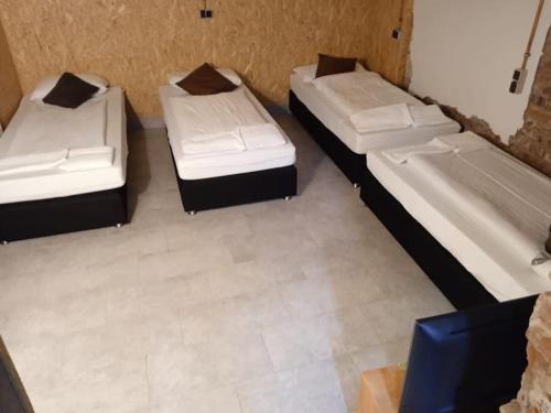 a group of three beds in a room at Flaty-Bielefeld Handwerker Rustikal in Bielefeld