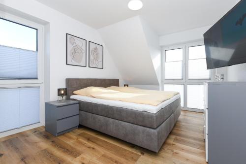 Ένα ή περισσότερα κρεβάτια σε δωμάτιο στο Ferienhaus Küstenfein