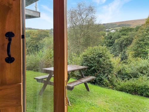 a view of a picnic table outside a door at Ormrods in Withypool